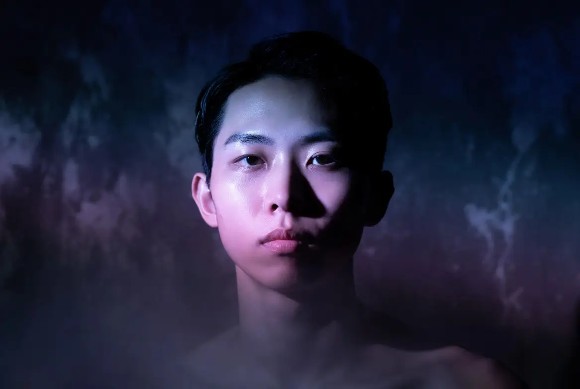 A high-end album cover portrait featuring controlled lighting and a moody centered composition.